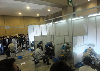 Judges seated during the welding technique contest